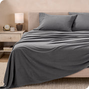 View of fleece sheets from the end of a bed with the top sheet draped over the side and end