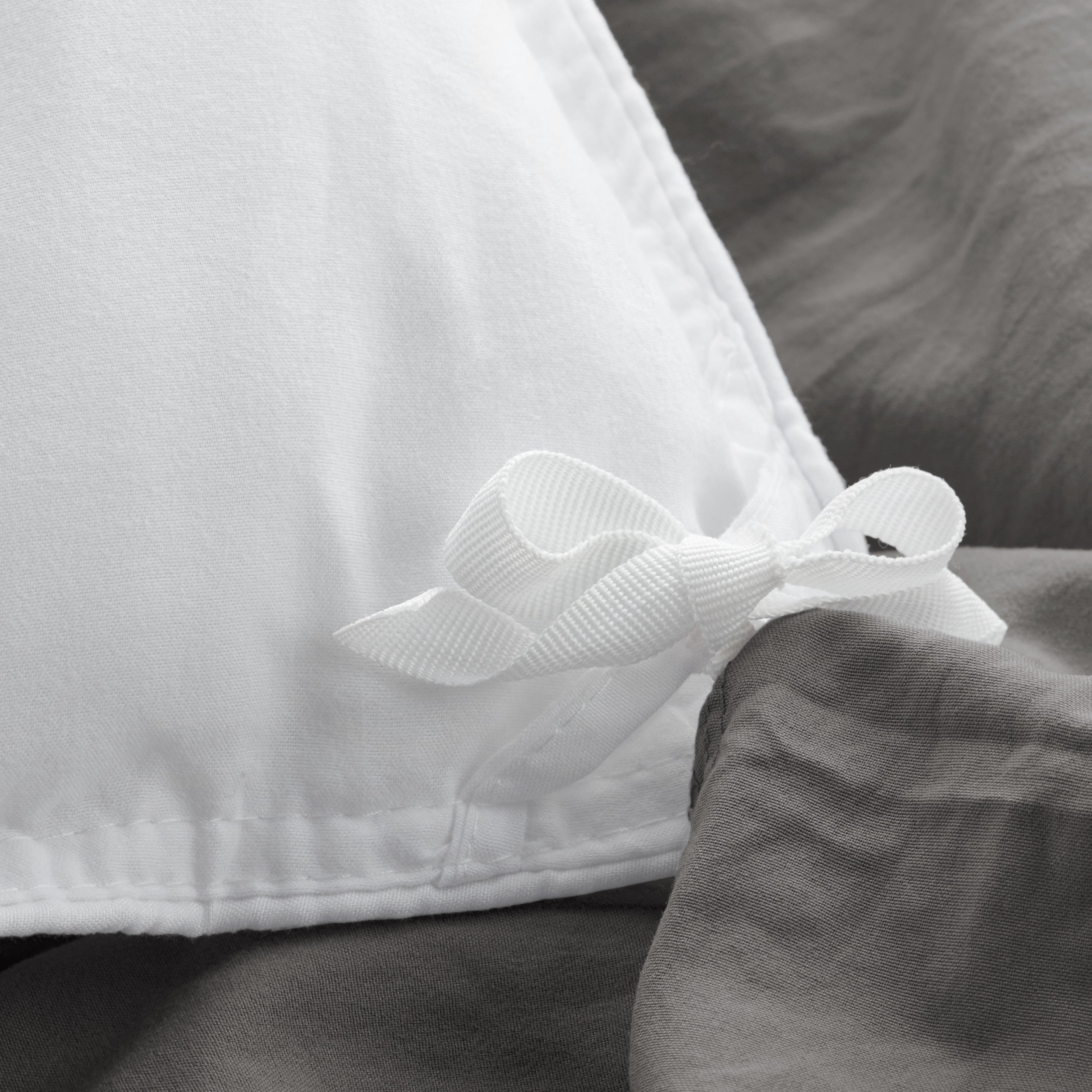 Close up of cloth ties for attaching duvet insert to inside of duvet cover