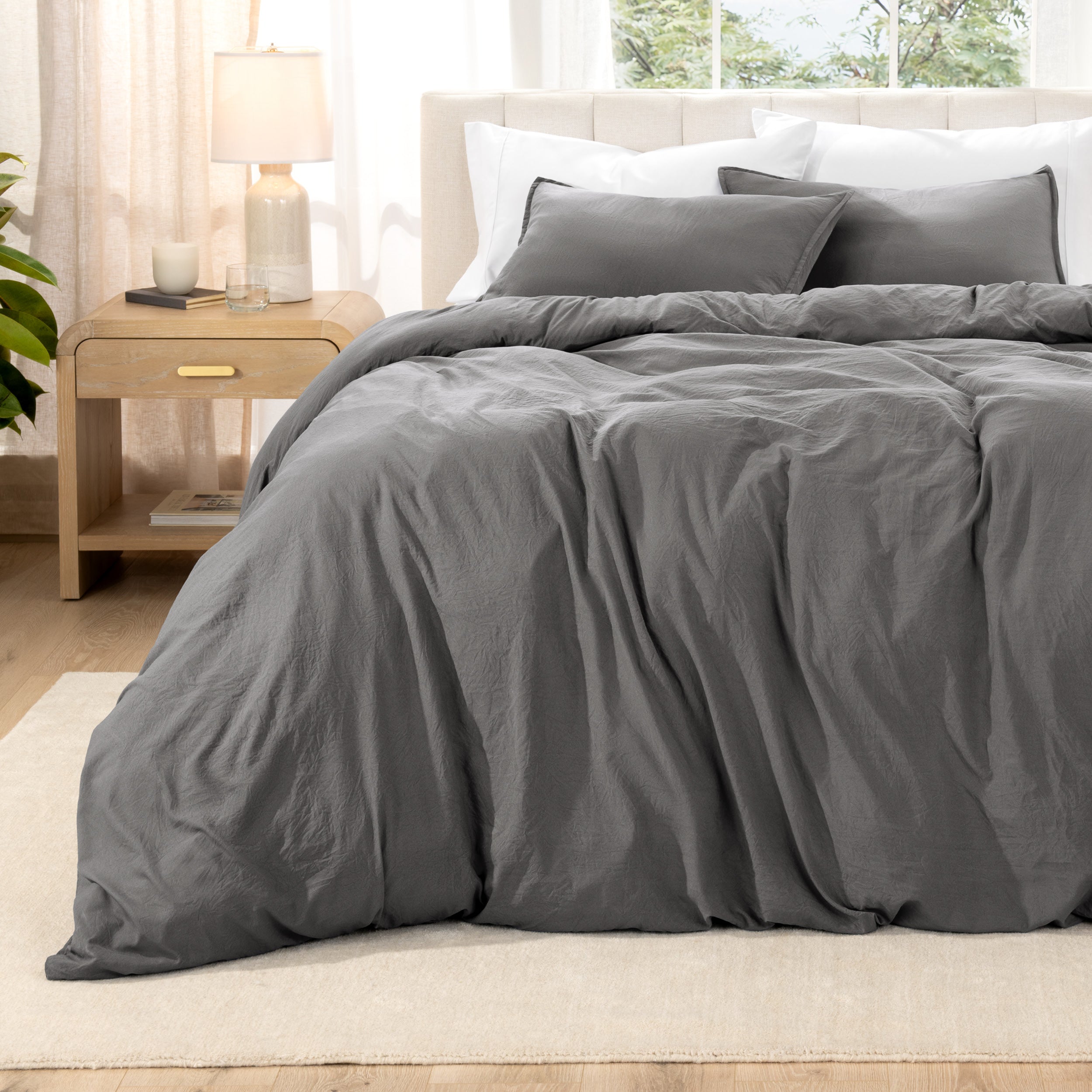 Relaxing room scene with a duvet cover laid out over the bed
