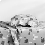 A flannel pillowcase on a pillow set on a bed with matching sheets