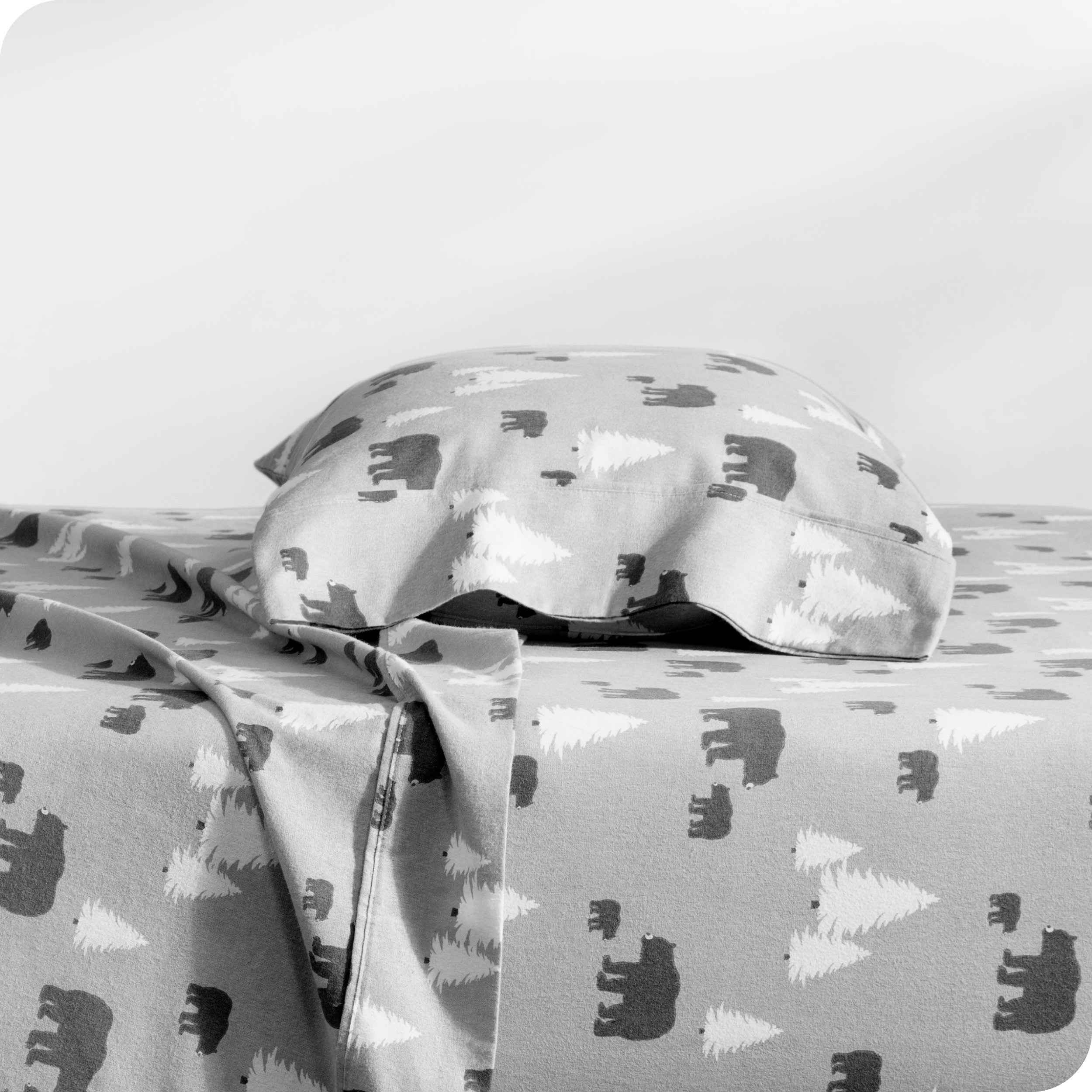 A flannel pillowcase on a pillow set on a bed with matching sheets