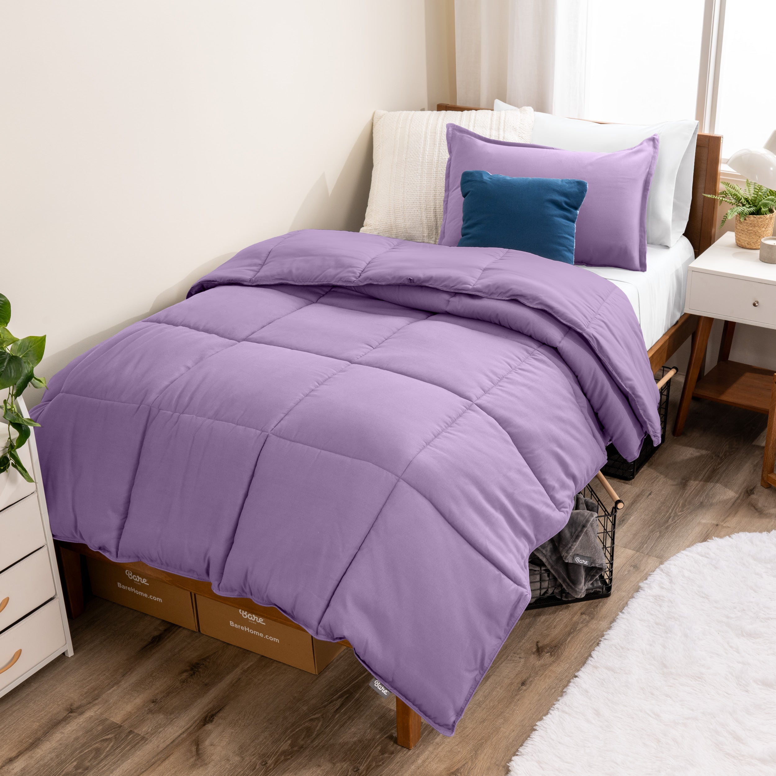 A modern bed with a down alternative comforter set on it