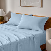 A bed made with matching flannel sheets and pillowcases