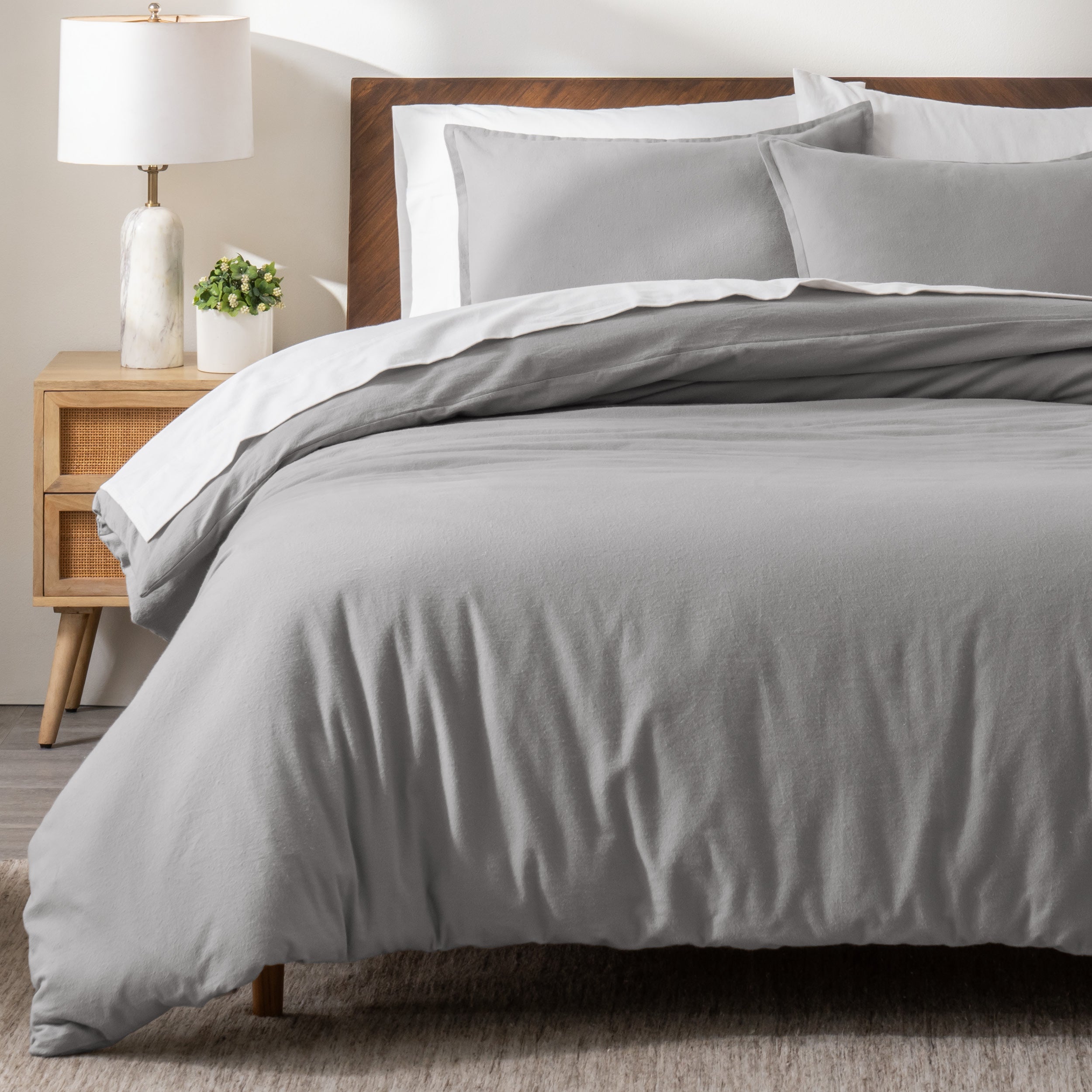 A modern bed with a flannel duvet cover set consisting of the duvet cover and two pillows.