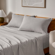 A bed made with matching flannel sheets and pillowcases