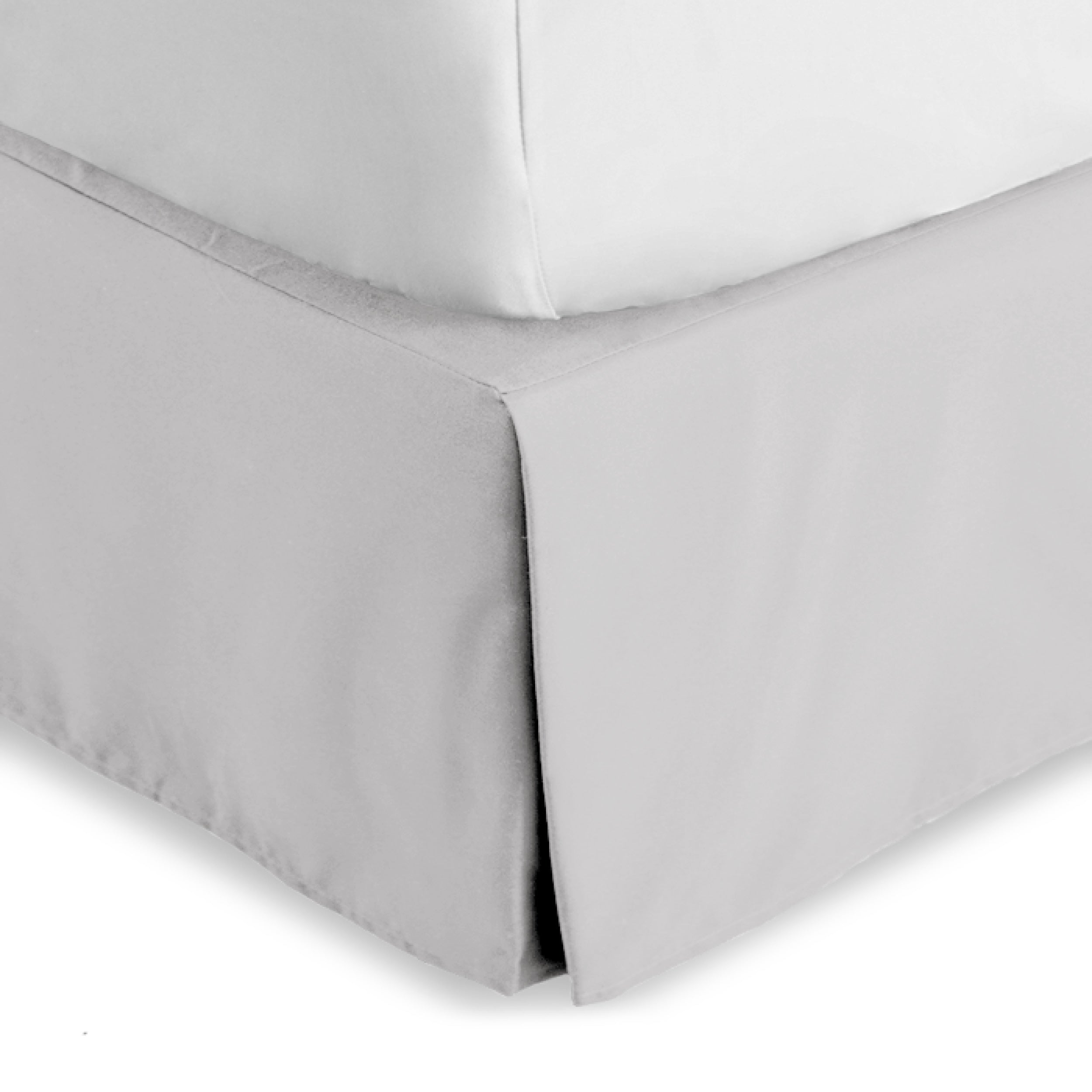 The corner of a bed skirt on a bed frame
