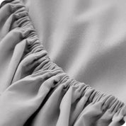 A close up of the elastic of a microfiber fitted sheet.