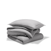 A comforter folded with a matching pillow sham stacked on top