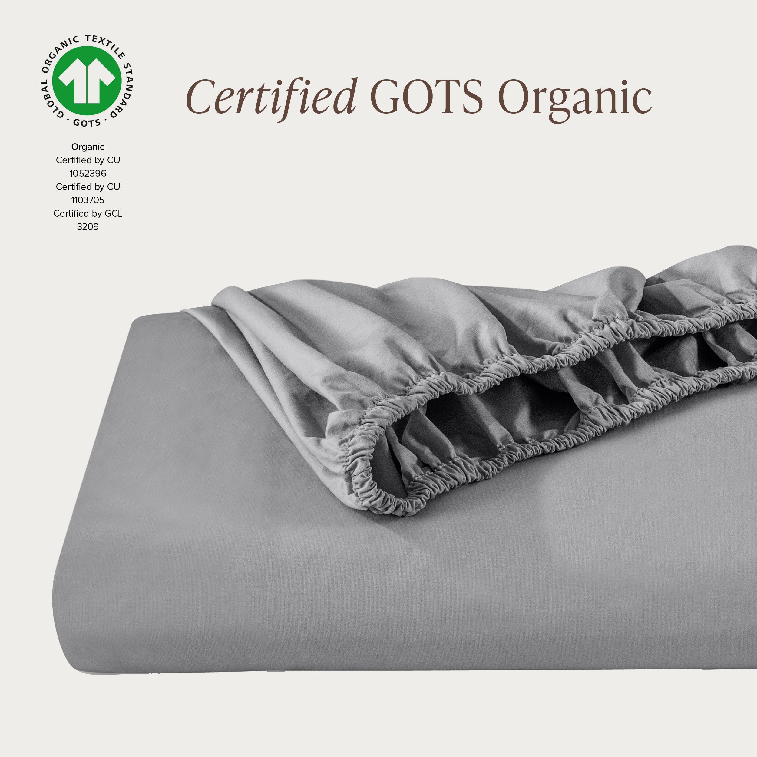 A single fitted sheet folded neatly showing part of the elastic. The fitted sheet is Certified GOTS Organic.