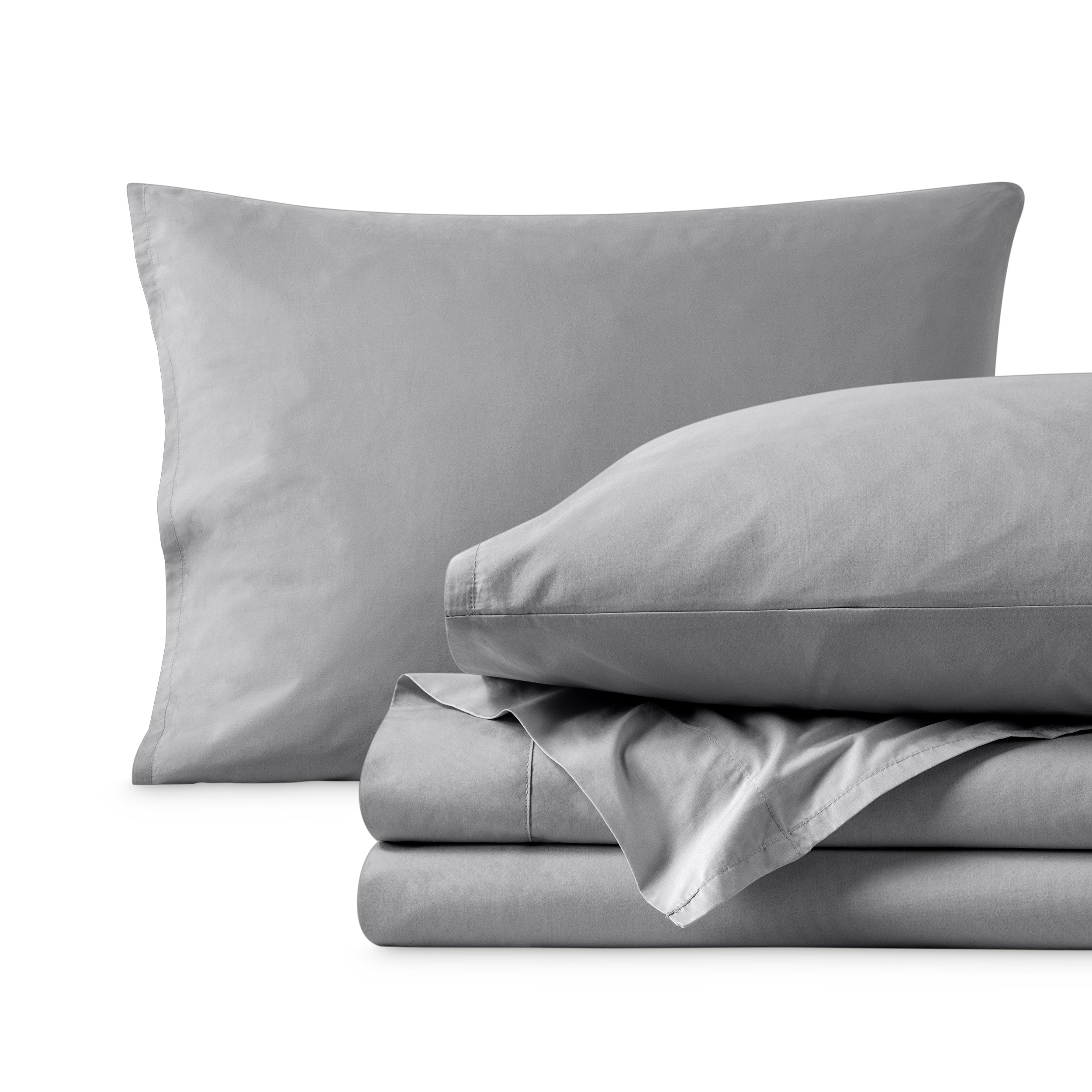 Percale sheet set with two pillows and folded sheets on a white background