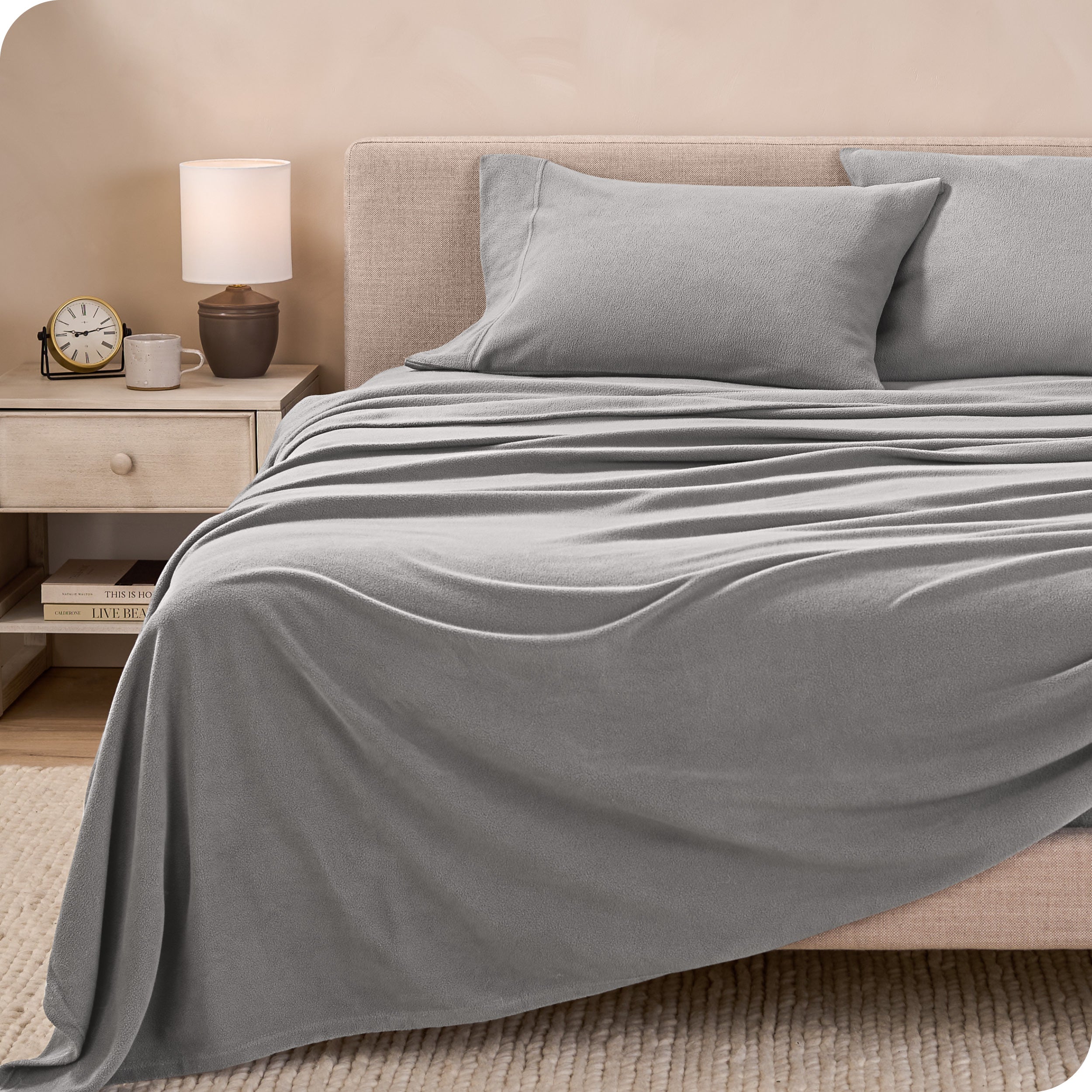 View of fleece sheets from the end of a bed with the top sheet draped over the side and end