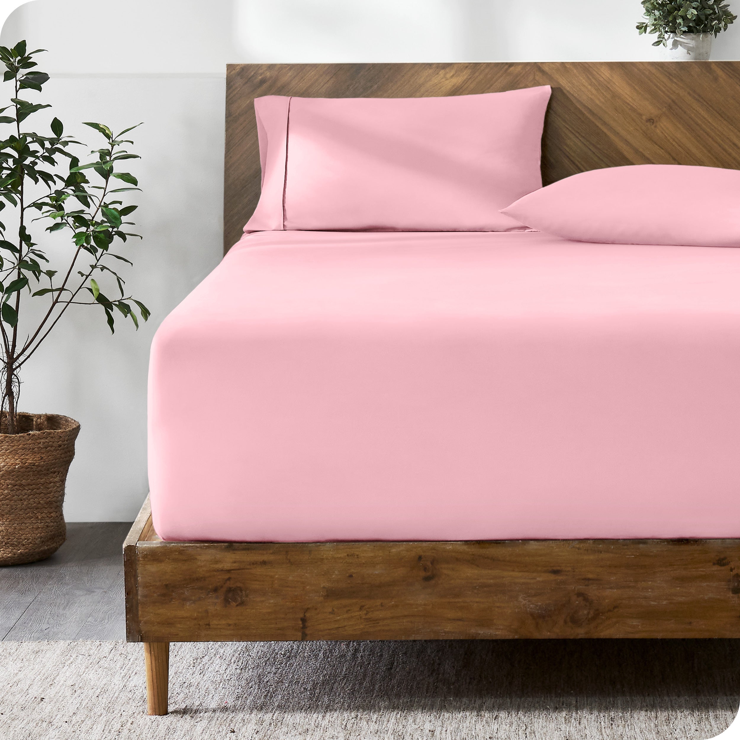 A modern bed with a fitted microfiber sheet made on the mattress.