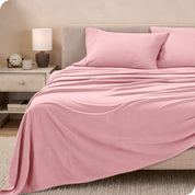 View of fleece sheets from the end of a bed with the top sheet draped over the side and end