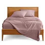 Microfiber sheet set on a bed with a wooden bed frame