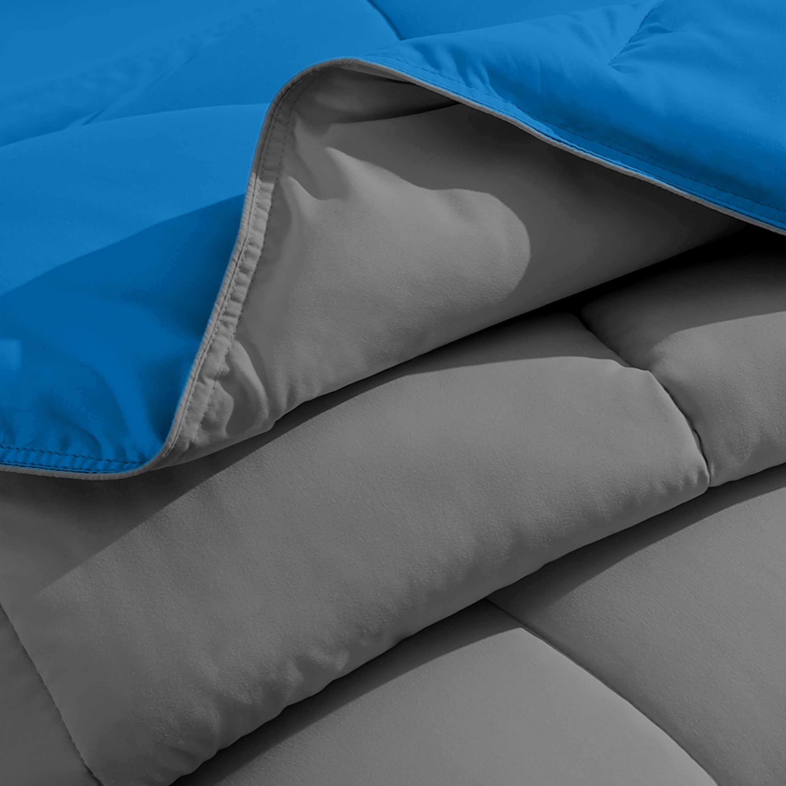 Close up of the reversible comforter showing the box stitching and the two colors