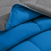 Close up of the reversible comforter showing the box stitching and the two colors