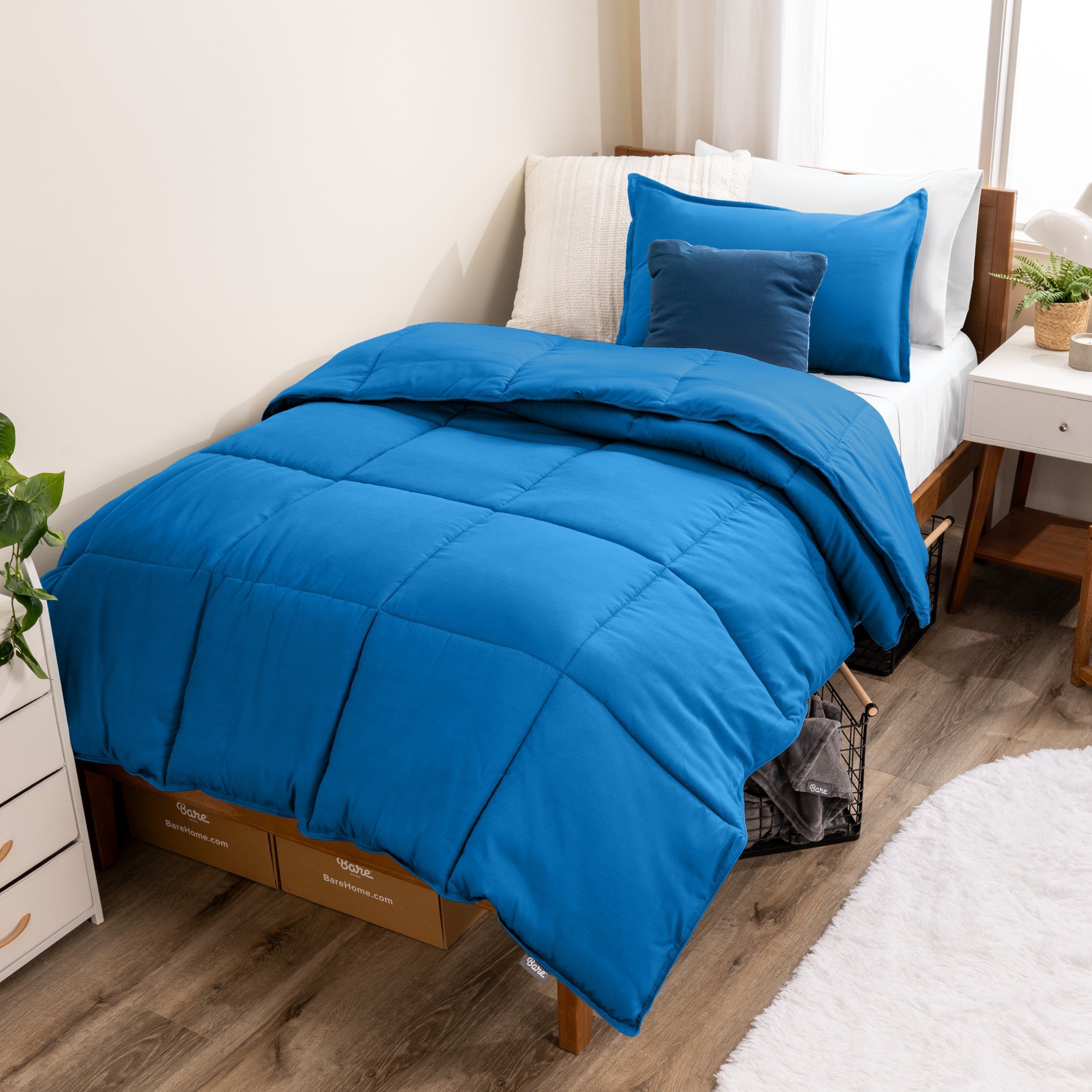 A modern bed with a down alternative comforter set on it