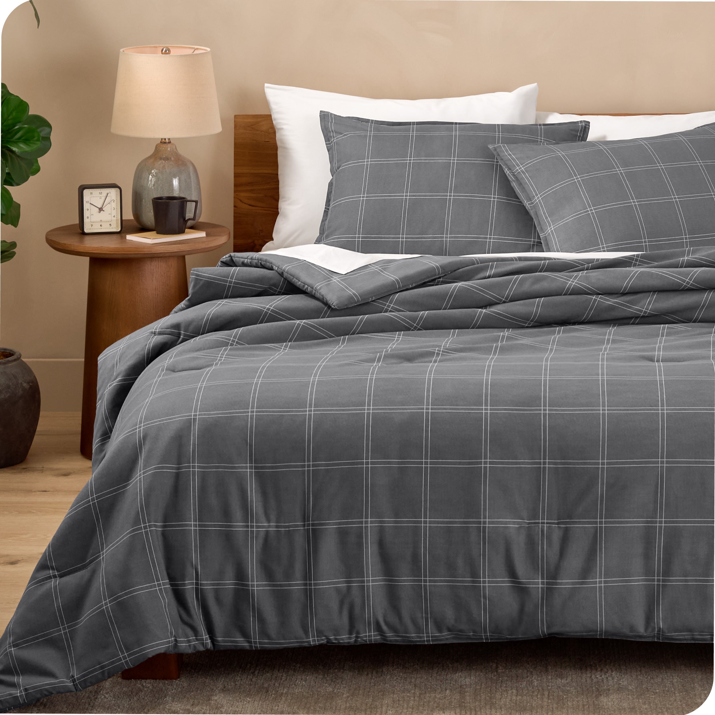 A comforter set on a bed in a bright modern room