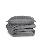 A comforter folded with a matching pillow sham stacked on top