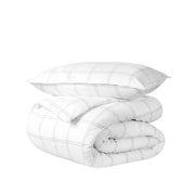 A comforter folded with a matching pillow sham stacked on top