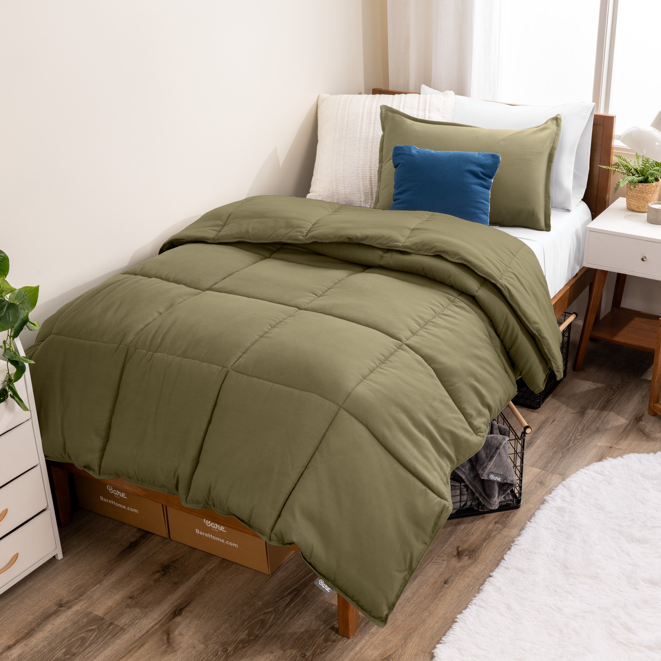 A modern bed with a down alternative comforter set on it