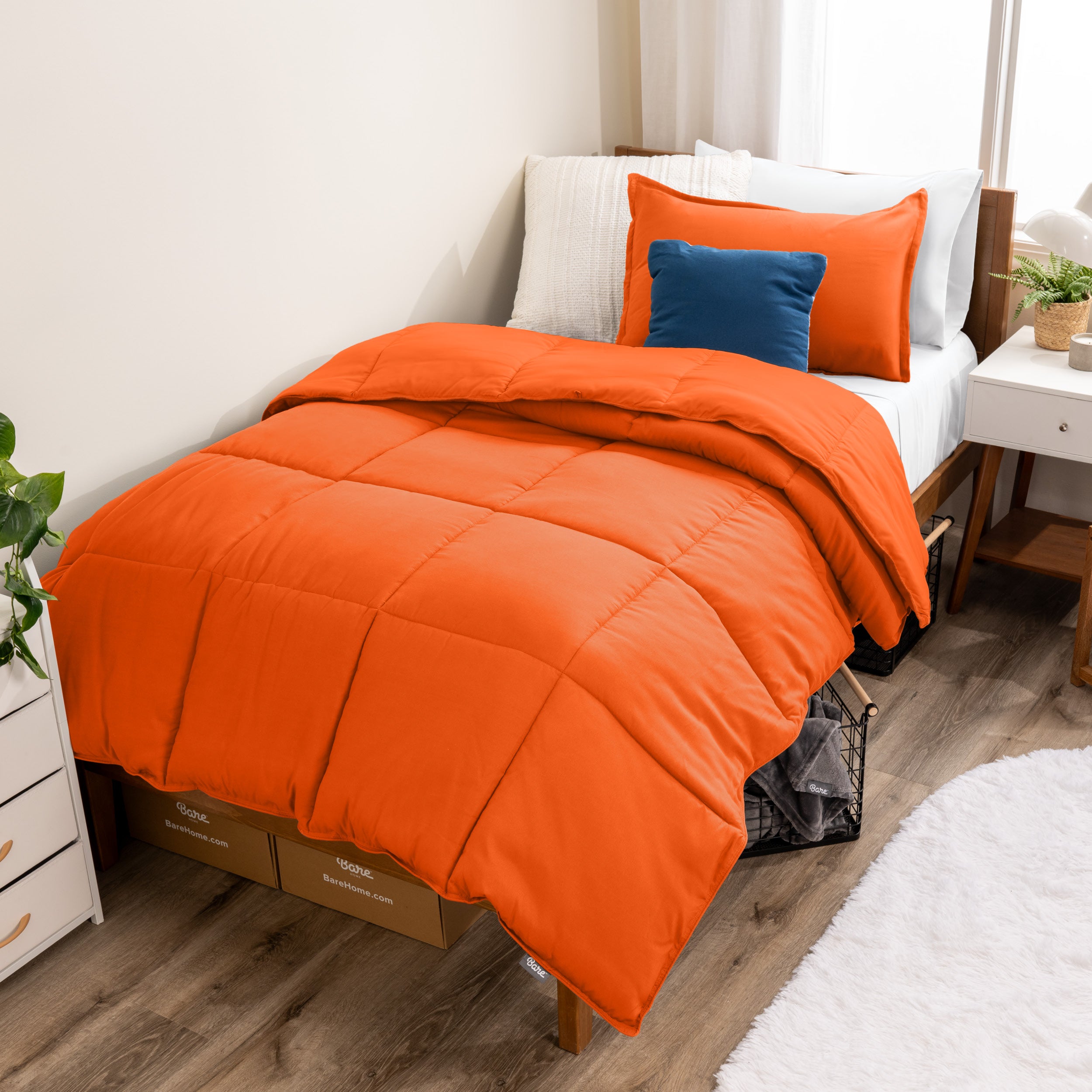 A modern bed with a down alternative comforter set on it
