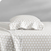 A sideview of a modern bed with a printed microfiber sheet set.