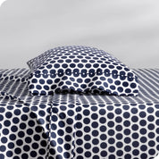 A sideview of a modern bed with a printed microfiber sheet set.