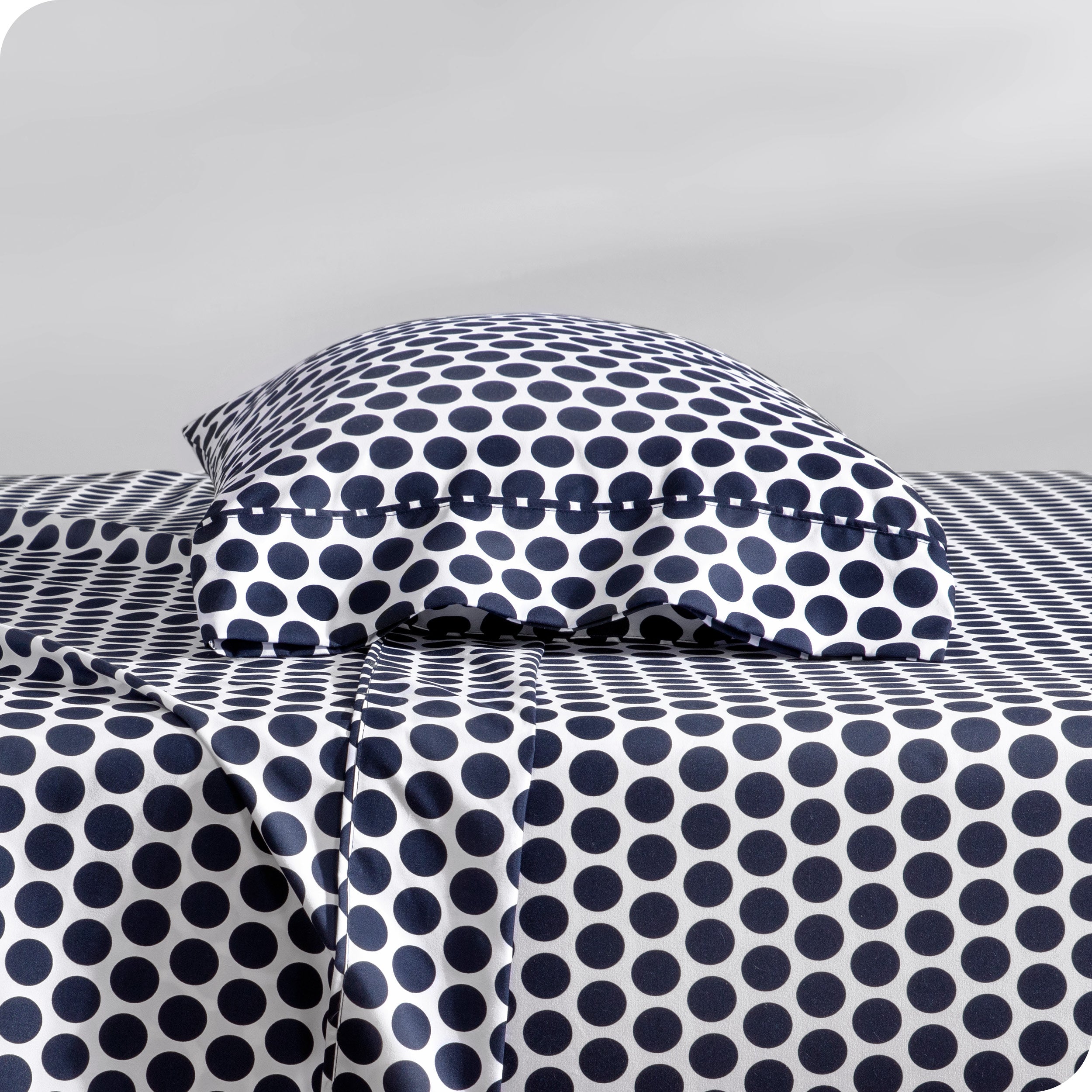 A sideview of a modern bed with a printed microfiber sheet set.