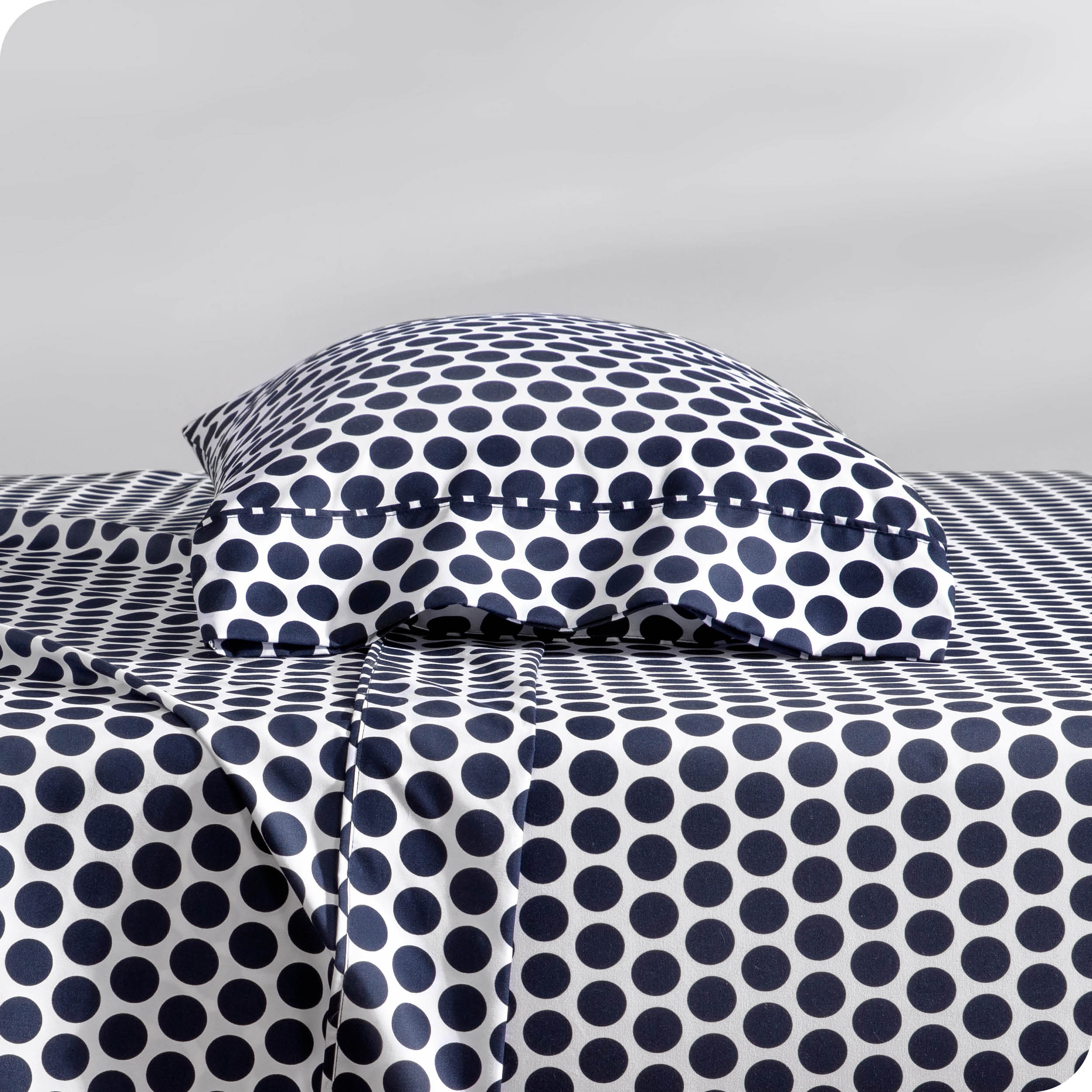 A sideview of a modern bed with a printed microfiber sheet set.