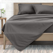 View from the end of a modern bed made with a microfiber sheet set with a modern print.