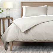 A modern bed with a pinstripe comforter duvet set