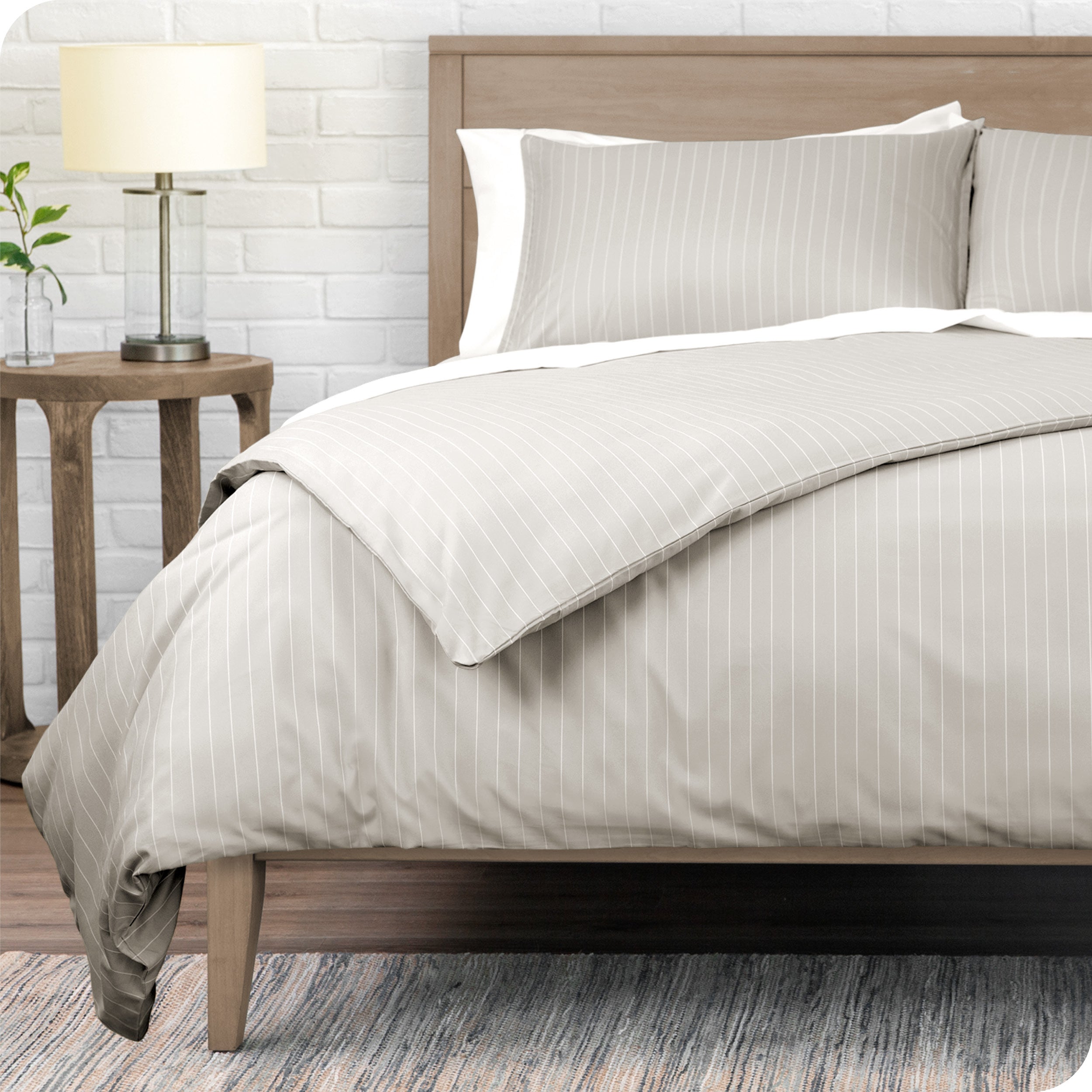 A modern bed with a pinstripe comforter duvet set