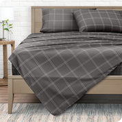 View from the end of a modern bed made with a microfiber sheet set with a modern print.