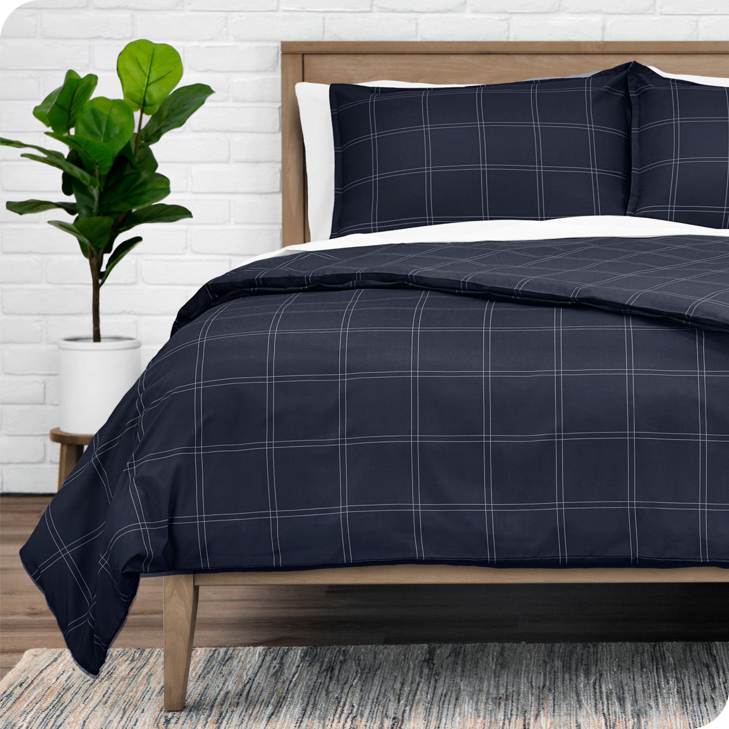 A modern bed with a plaid duvet set