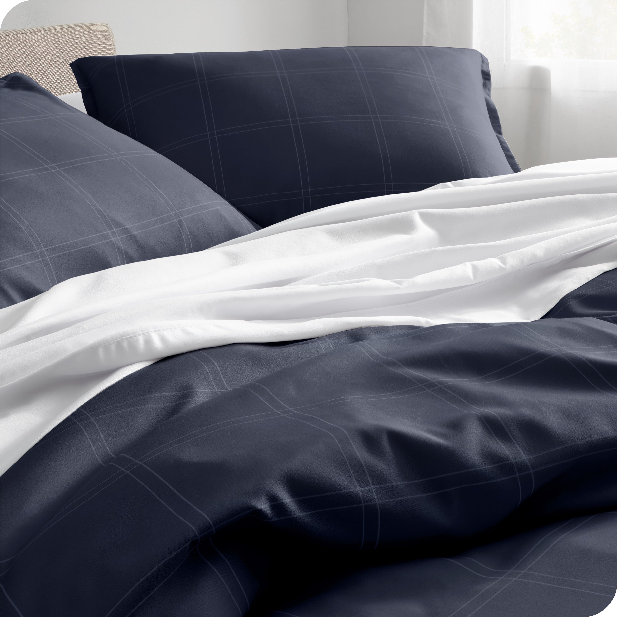 Close up of a modern bed with a printed duvet cover on it.