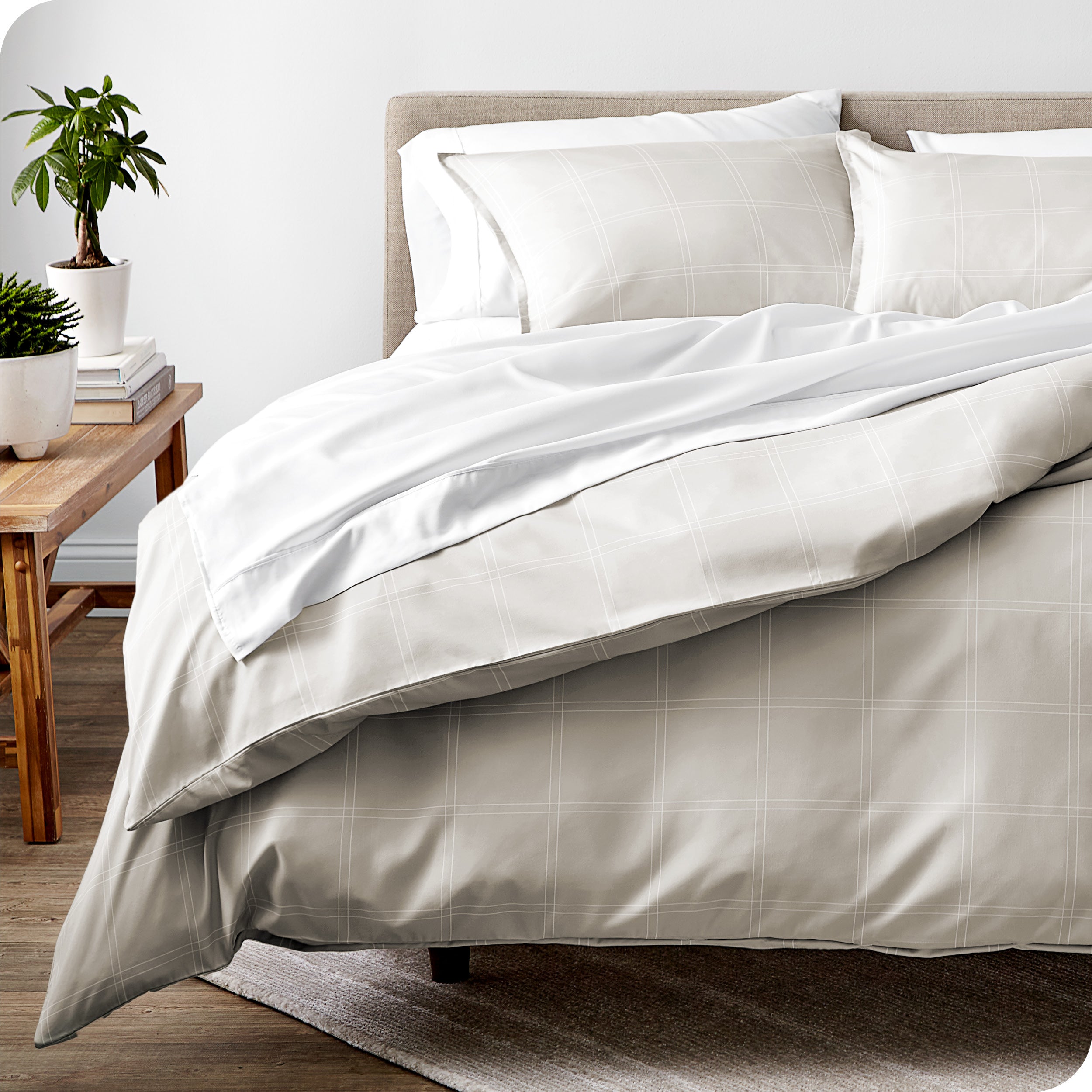 A modern bed with a plaid comforter duvet set