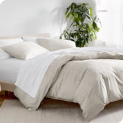 A diagonal view of a modern bed with a printed duvet cover on it.