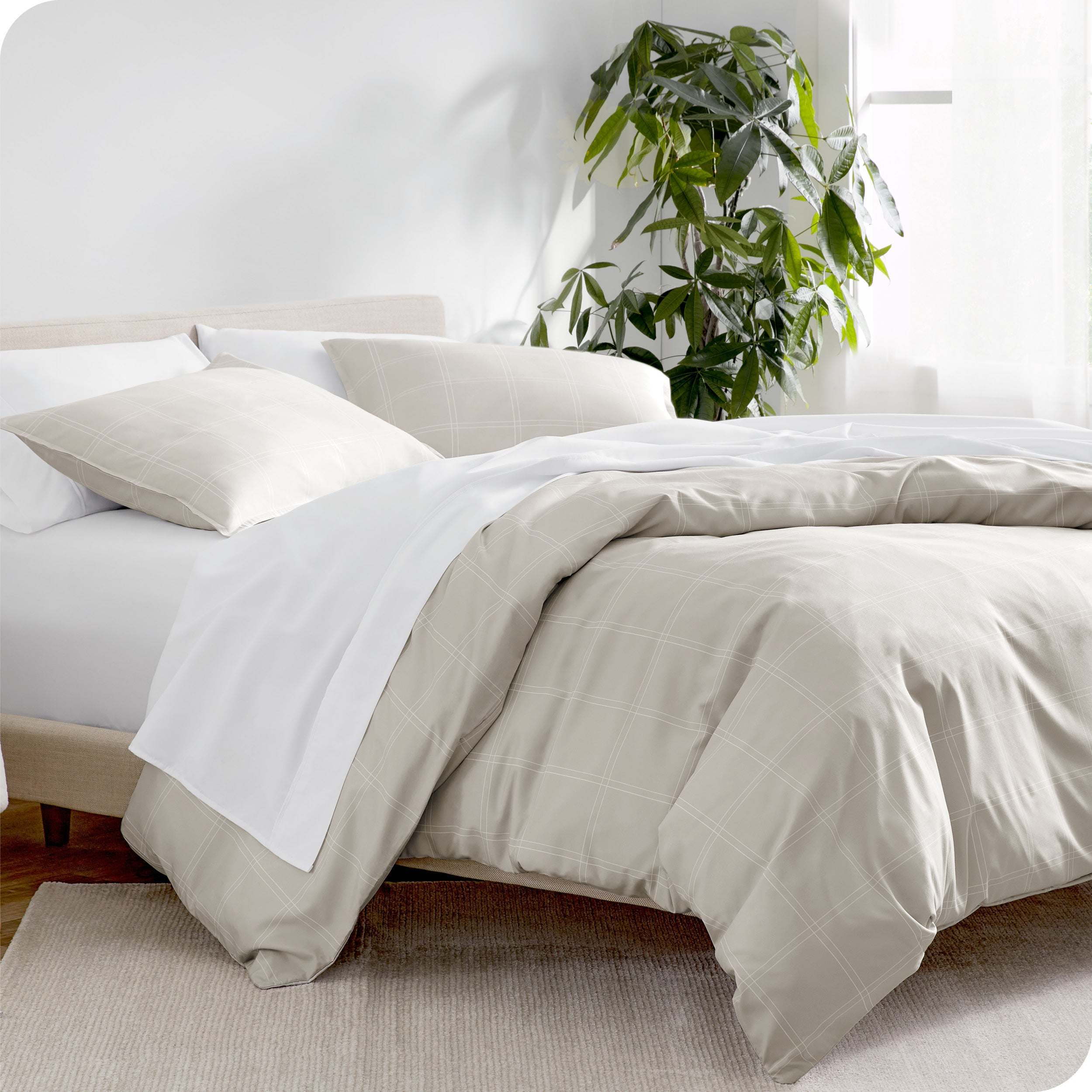 A diagonal view of a modern bed with a printed duvet cover on it.