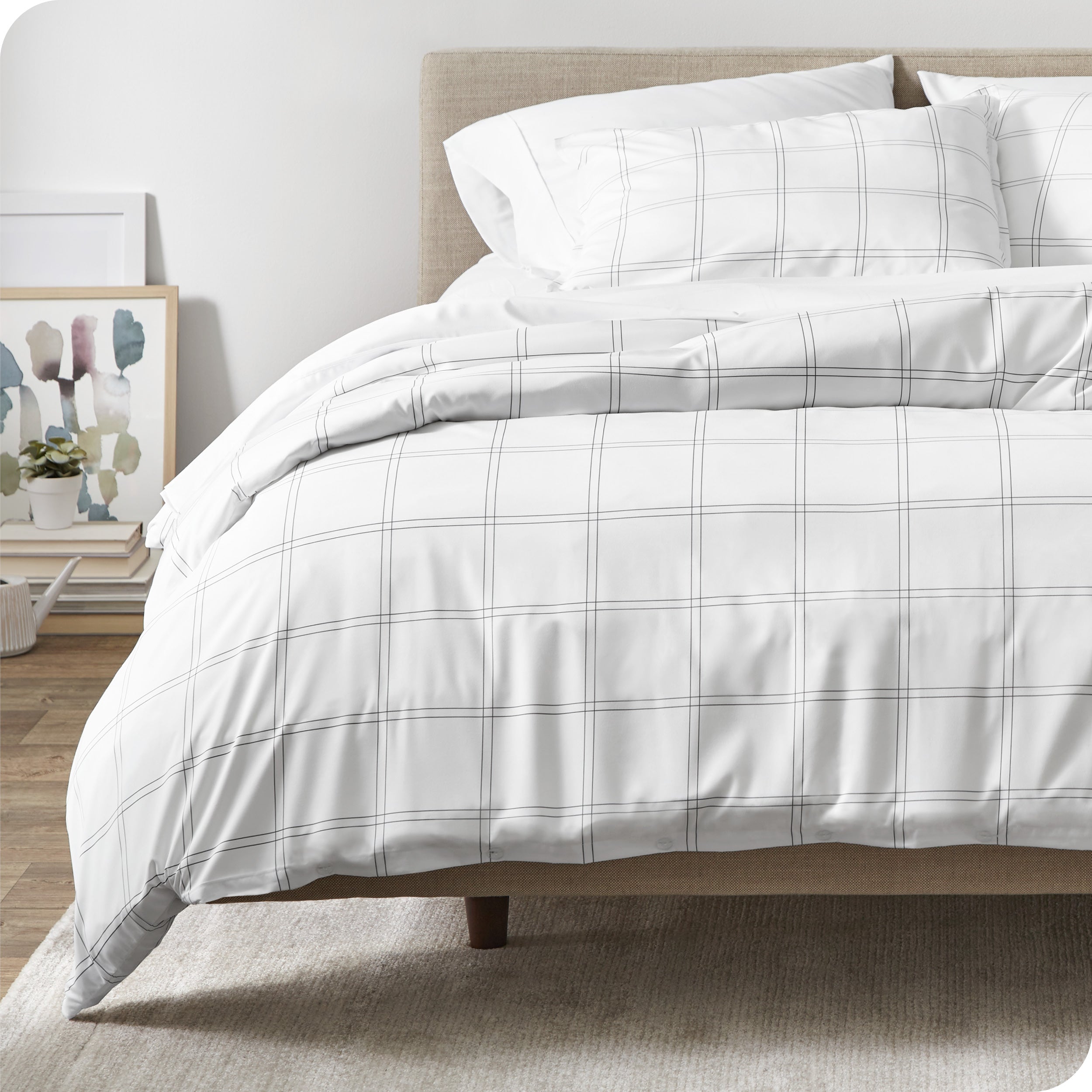 A modern bed with a plaid comforter duvet set