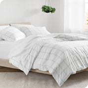 A diagonal view of a modern bed with a printed duvet cover on it.