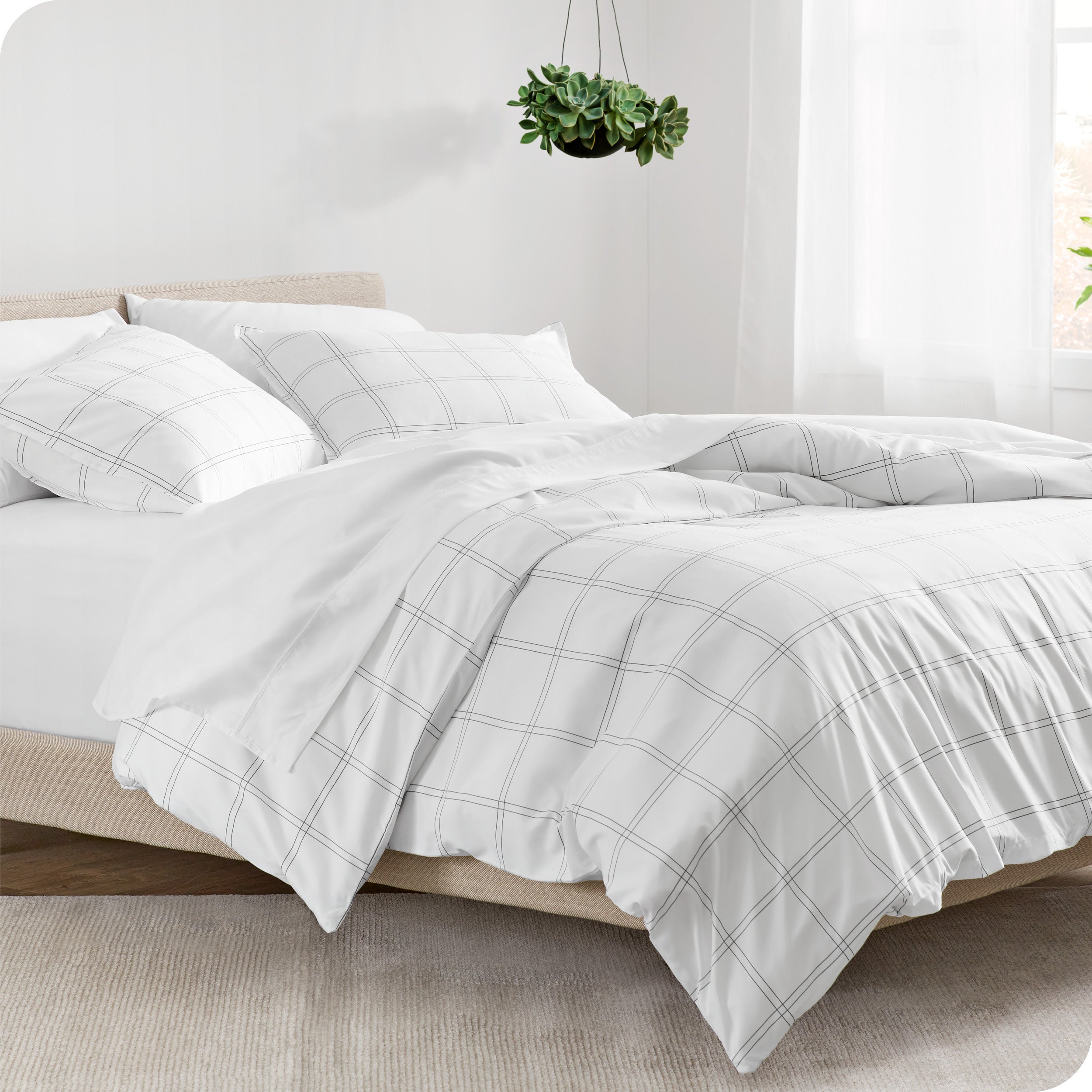 A diagonal view of a modern bed with a printed duvet cover on it.