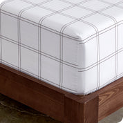 Close up view of the corner of a mattress with the microfiber fitted sheet to show how it fits.