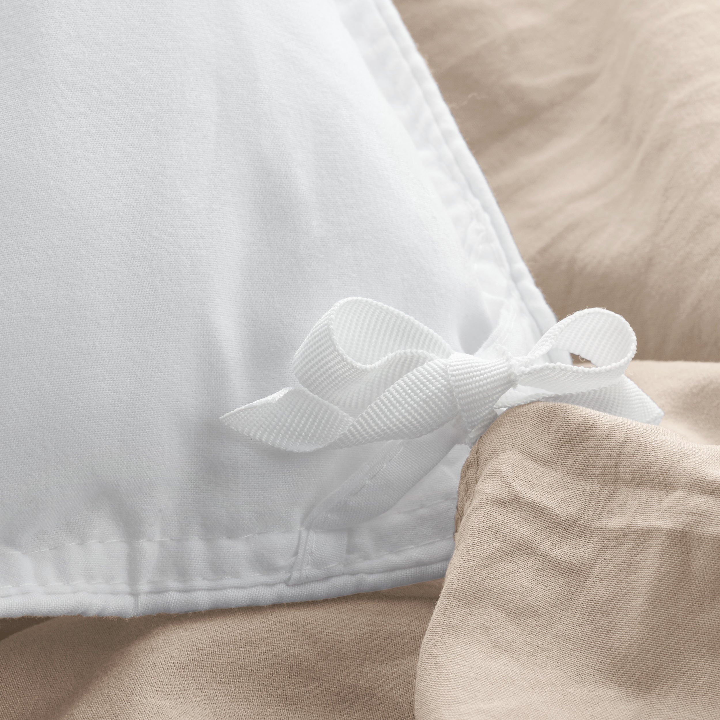 Close up of cloth ties for attaching duvet insert to inside of duvet cover