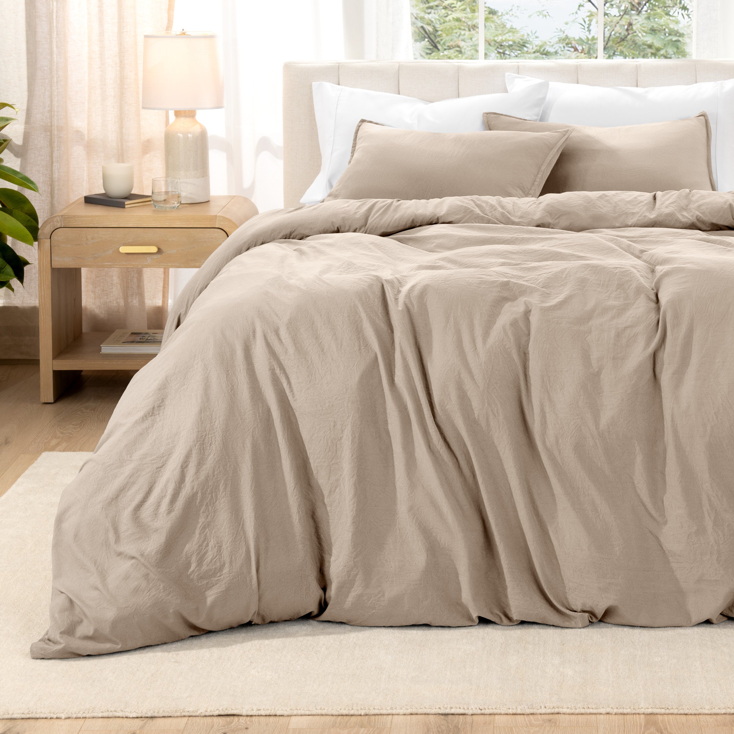 Relaxing room scene with a duvet cover laid out over the bed