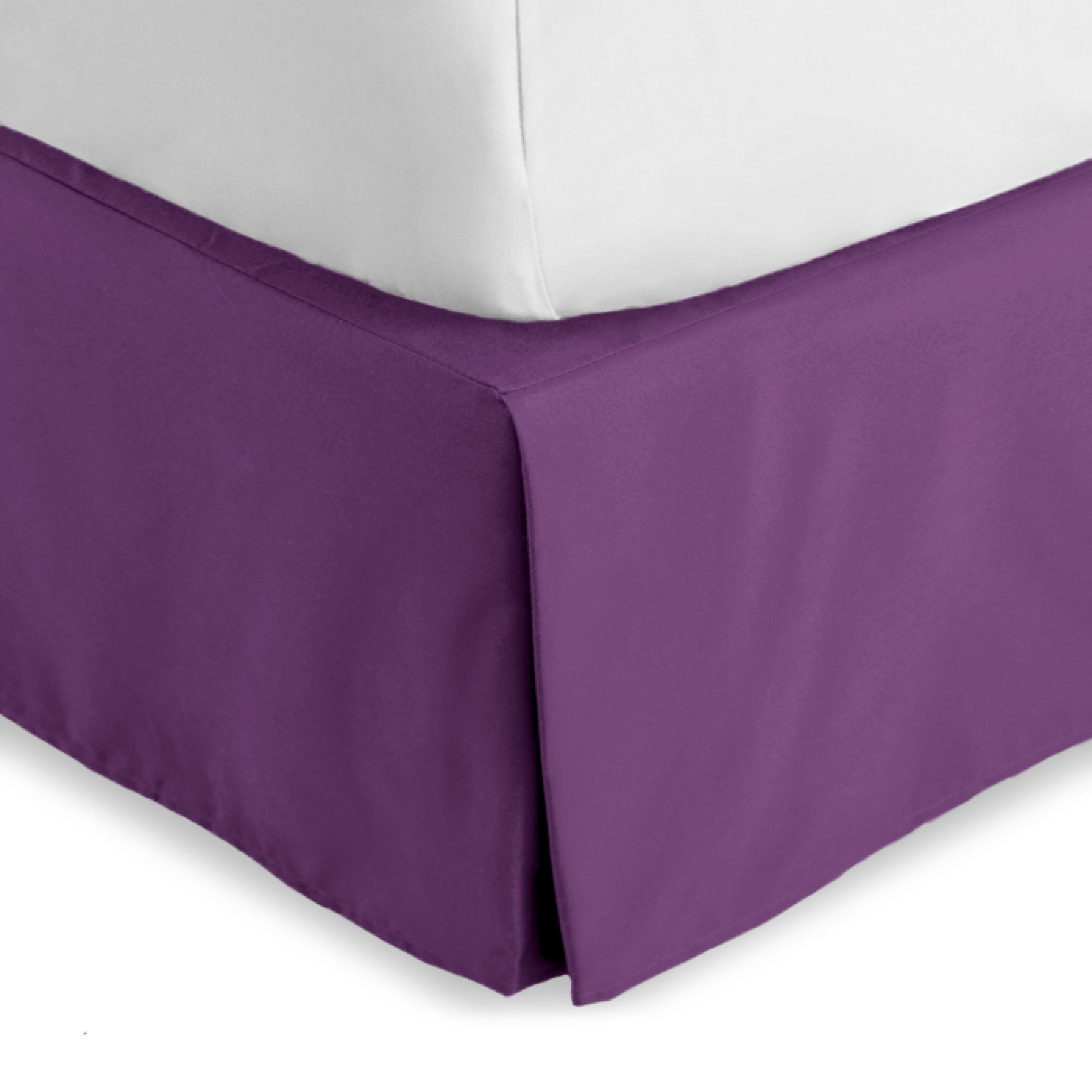 The corner of a bed skirt on a bed frame