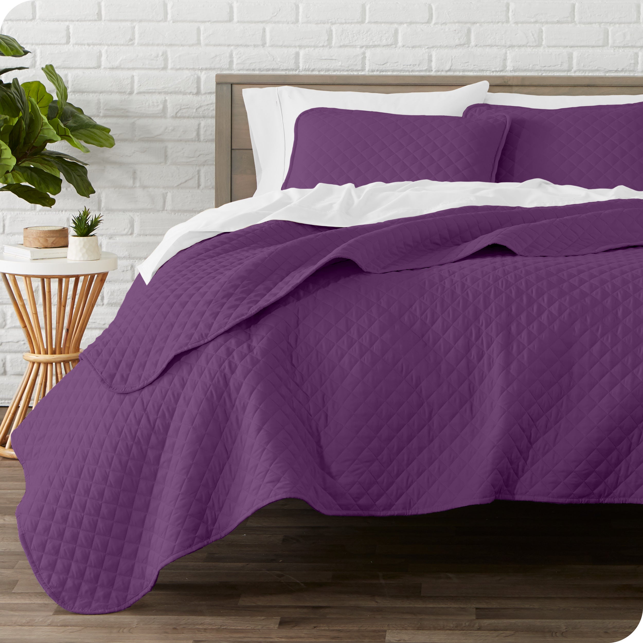 A quilted coverlet set on a bed
