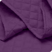 Close up of a coverlet showing the stitching