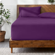 A modern bed with a fitted microfiber sheet made on the mattress.