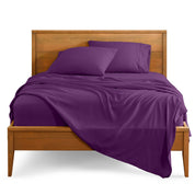 Microfiber sheet set on a bed with a wooden bed frame